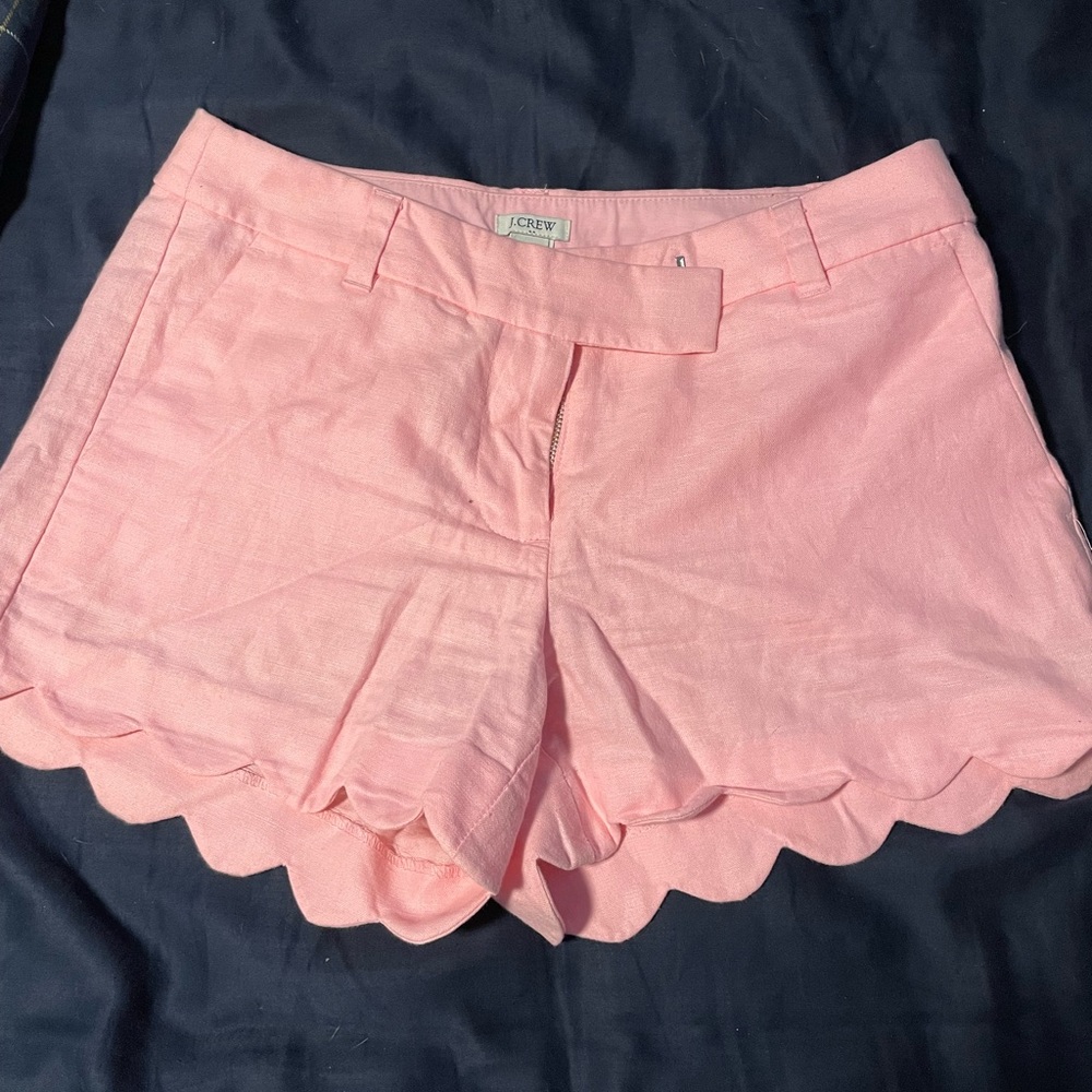 Pink, scallop-hemmed women’s summer shorts from J. crew.